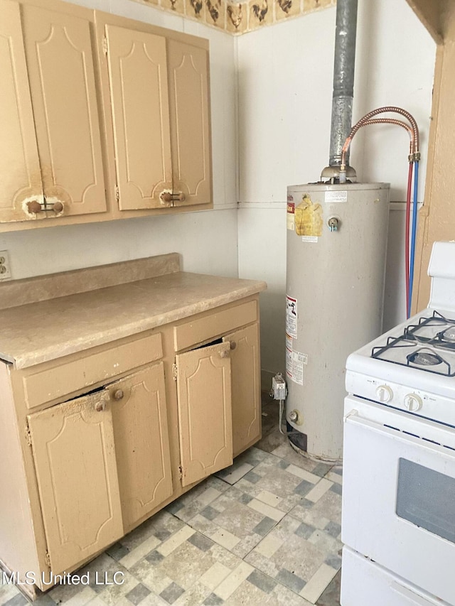 810 S Edwards Ave, Clarksdale, MS 38614 - kitchen with white range with gas stovetop, water heater, light countertops, and light floors
