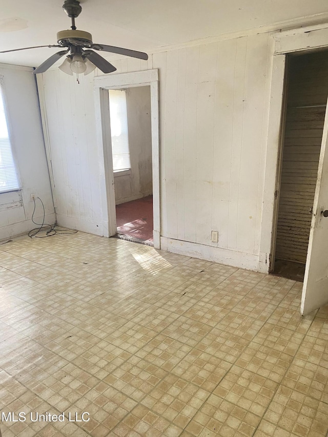 810 S Edwards Ave, Clarksdale, MS 38614 - spare room with wooden walls, a ceiling fan, and plenty of natural light