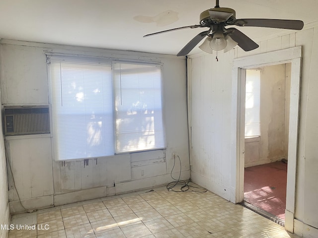 810 S Edwards Ave, Clarksdale, MS 38614 - spare room featuring wood walls, ceiling fan, an AC wall unit, and light floors
