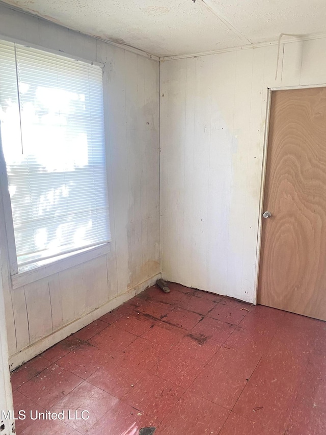 810 S Edwards Ave, Clarksdale, MS 38614 - unfurnished room featuring tile patterned floors and wood walls