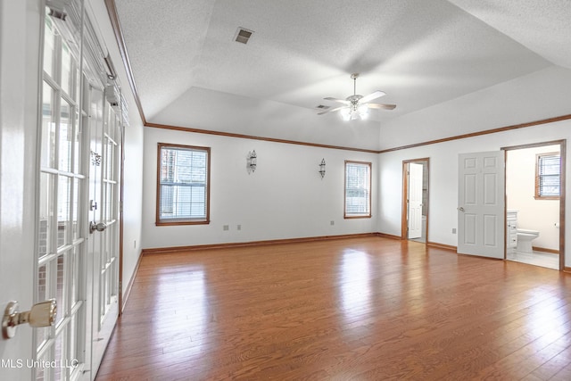 interior space with hardwood / wood-style floors, french doors, ceiling fan, and lofted ceiling