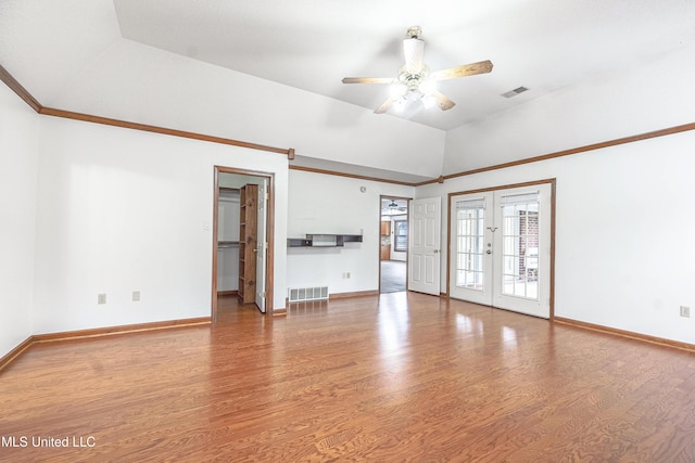 unfurnished living room with ceiling fan, french doors, and hardwood / wood-style flooring