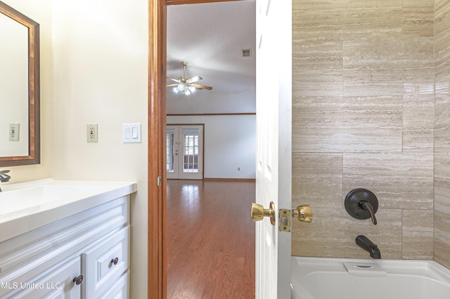 bathroom featuring shower / tub combination, ceiling fan, and vanity