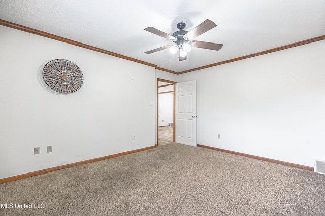 spare room featuring ceiling fan, ornamental molding, and carpet floors