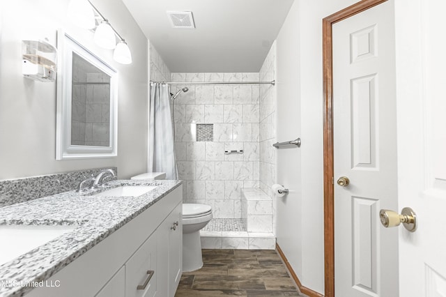 bathroom featuring a shower with curtain, vanity, toilet, and wood-type flooring