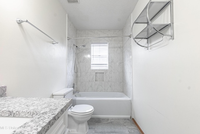 full bathroom featuring toilet, vanity, and tiled shower / bath