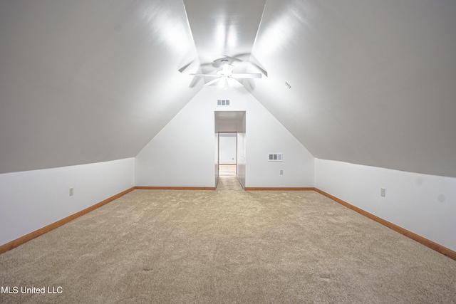 bonus room featuring light carpet, vaulted ceiling, and ceiling fan