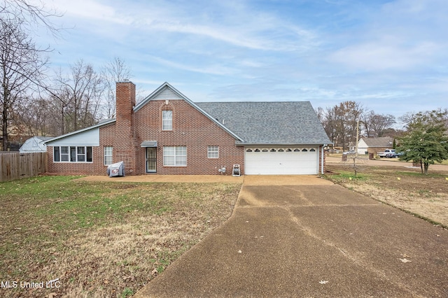 view of front of house featuring a front yard and a garage