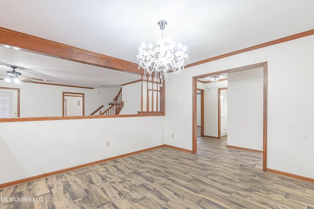 unfurnished room featuring ceiling fan with notable chandelier, wood-type flooring, and crown molding