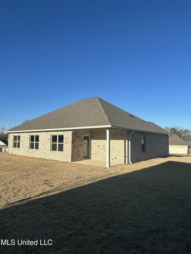 rear view of property with a yard