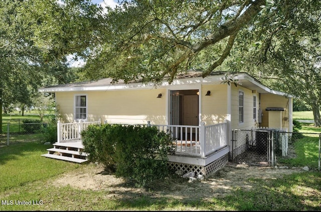 4466 Beatline Rd, Long Beach, MS 39560 - rear view of house featuring a yard, fence, and a wooden deck
