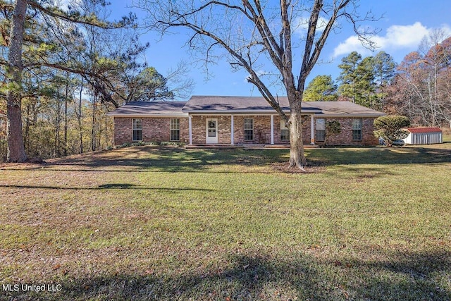 ranch-style house with a storage shed and a front lawn