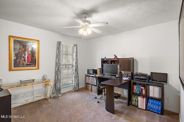 home office featuring ceiling fan, carpet flooring, and a textured ceiling