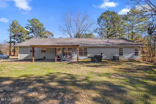 rear view of property with a patio area, a lawn, and cooling unit