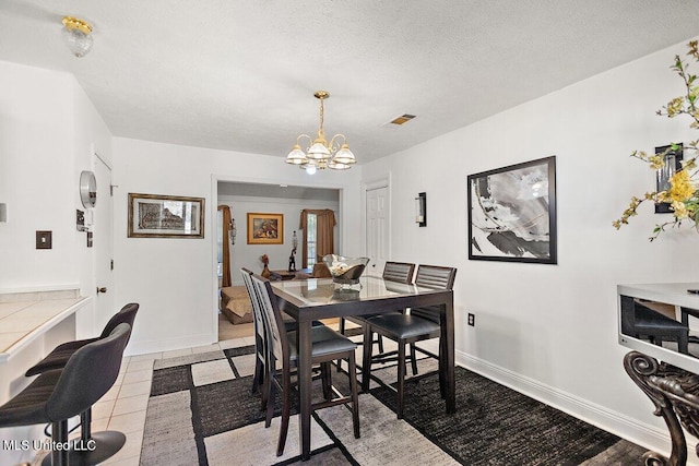 1085 Thomas Dr, Raymond, MS 39154 - dining area featuring a chandelier and baseboards