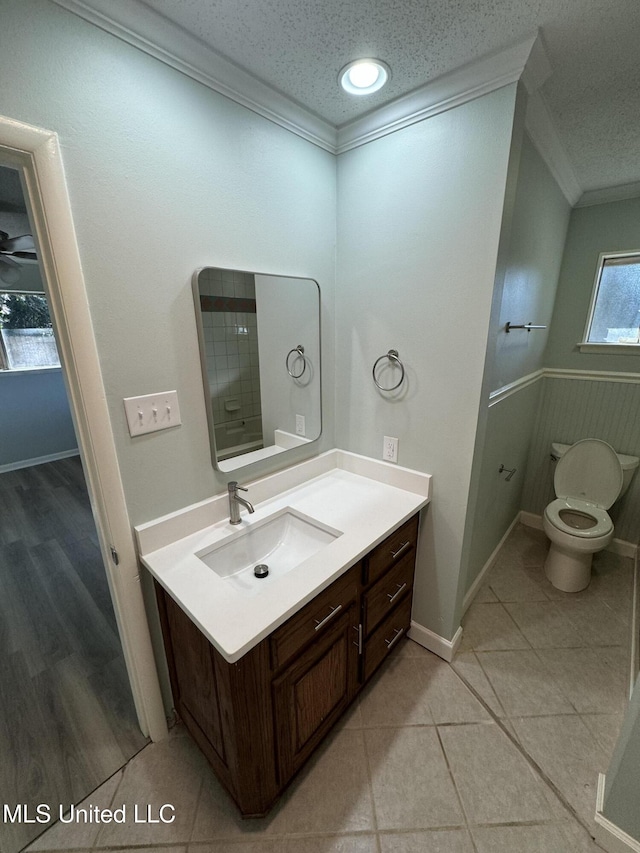 bathroom with crown molding, toilet, tile patterned flooring, and a textured ceiling