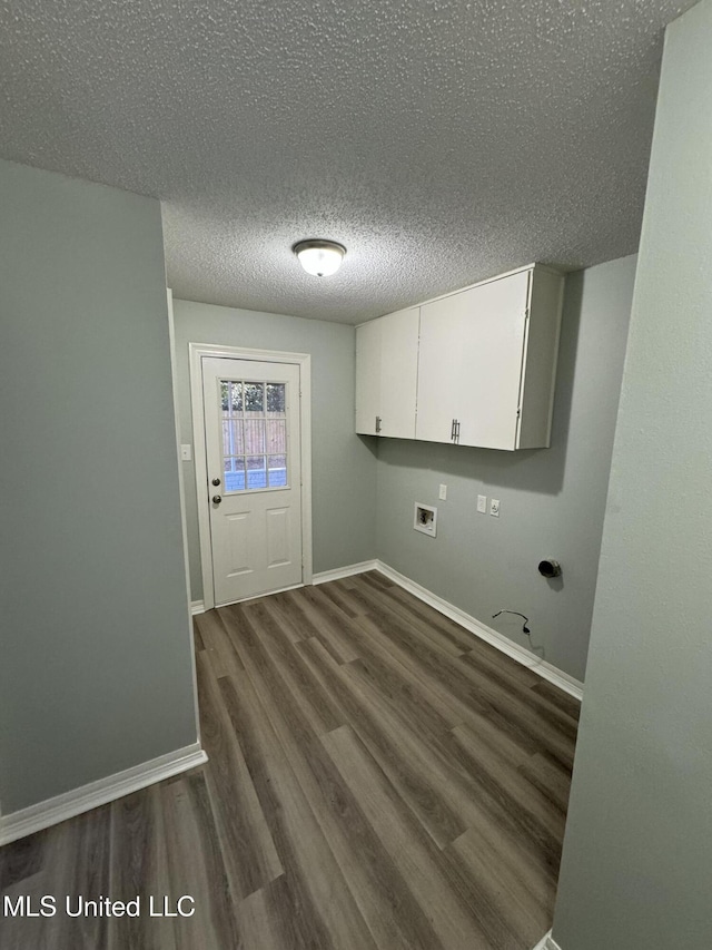 clothes washing area with cabinets, washer hookup, a textured ceiling, and dark hardwood / wood-style flooring