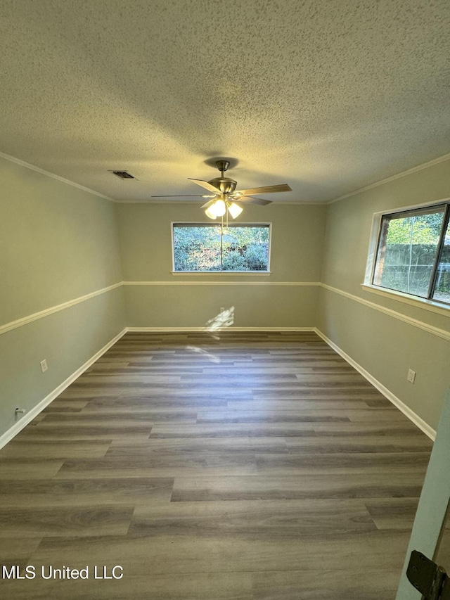 unfurnished room with hardwood / wood-style flooring, ornamental molding, ceiling fan, and a textured ceiling