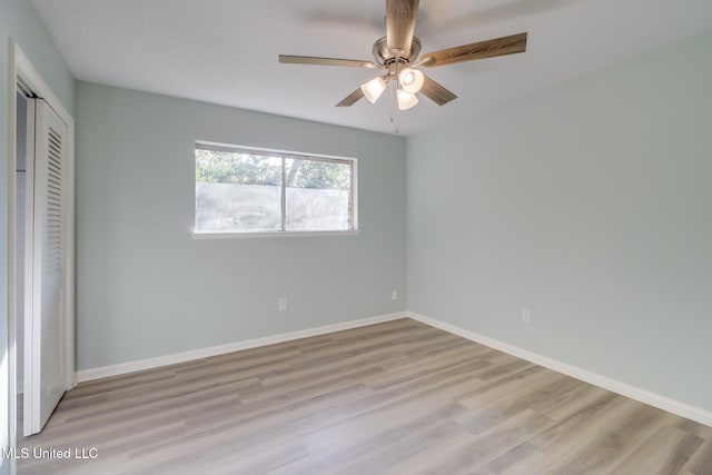 unfurnished bedroom with light hardwood / wood-style flooring, a closet, and ceiling fan