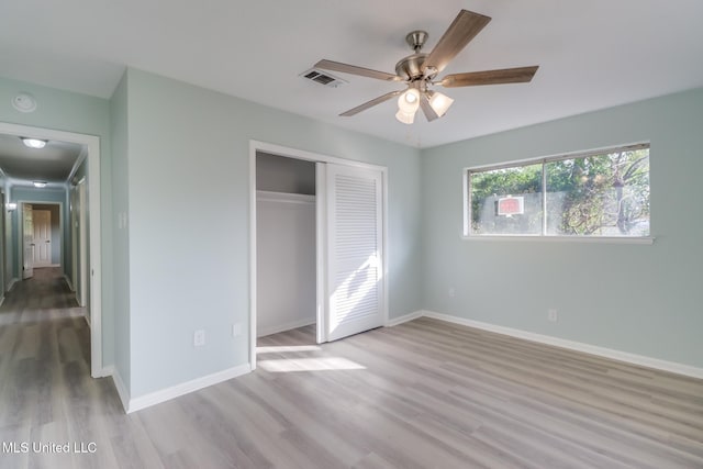 unfurnished bedroom with a closet, ceiling fan, and light wood-type flooring