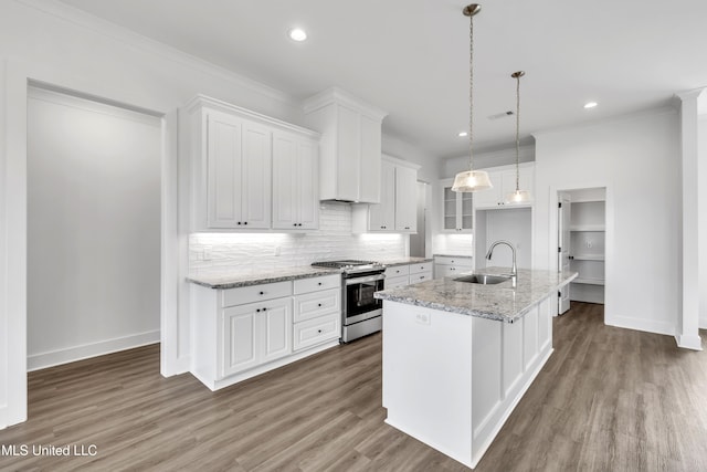 202 Crestwood Pl, Madison, MS 39110 - kitchen with stainless steel gas range oven, white cabinets, decorative backsplash, wood finished floors, and a kitchen island with sink