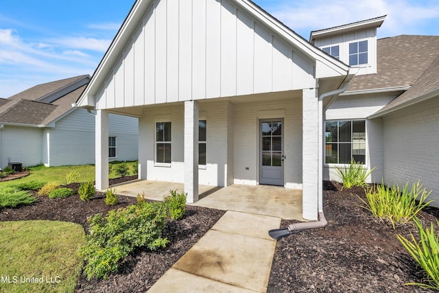 202 Crestwood Pl, Madison, MS 39110 - doorway to property featuring brick siding, board and batten siding, a shingled roof, and a porch