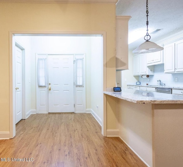 entryway featuring sink and light hardwood / wood-style floors