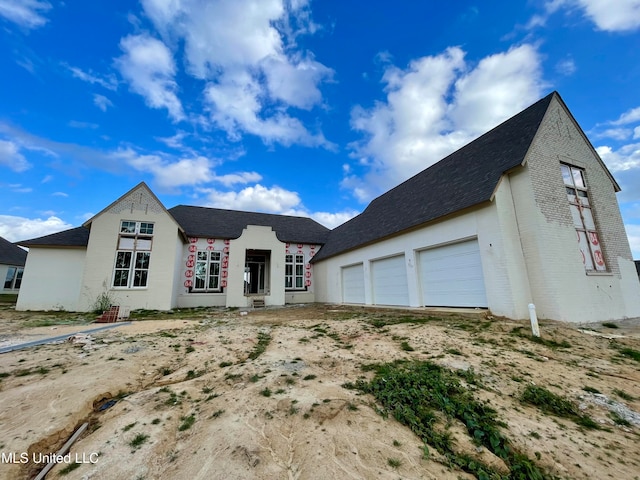 view of front of property with brick siding and a garage