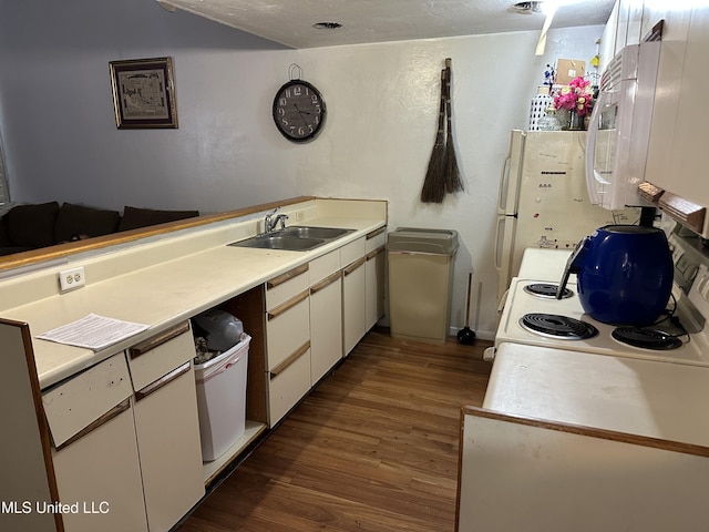 828 Oakleigh Ave Unit 15, Gulfport, MS 39507 - kitchen with light countertops, white microwave, a sink, and wood finished floors