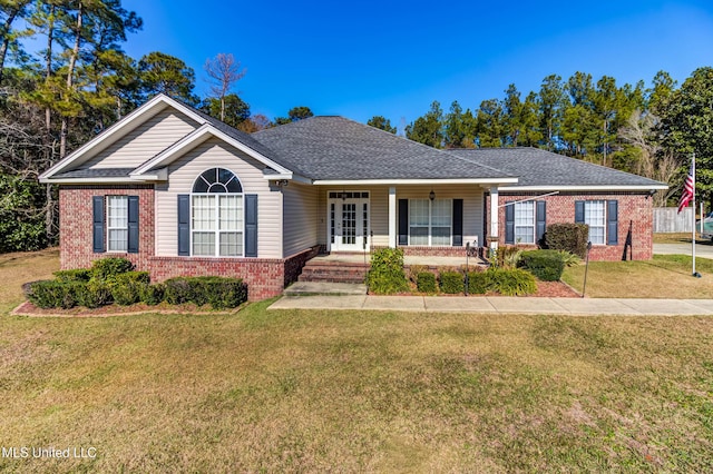 ranch-style home featuring covered porch, a front yard, and french doors