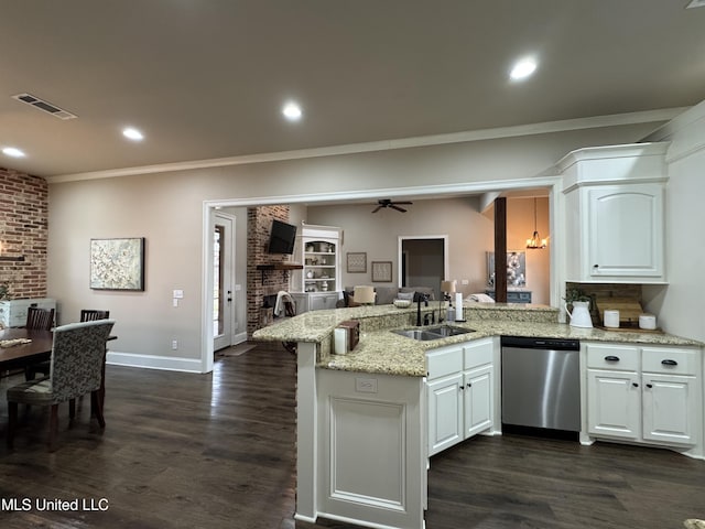 kitchen with sink, a fireplace, light stone countertops, white cabinets, and stainless steel dishwasher