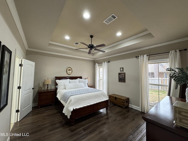 bedroom featuring a raised ceiling, crown molding, ceiling fan, and dark hardwood / wood-style flooring