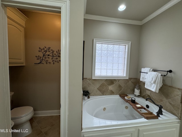 bathroom with tile patterned flooring, ornamental molding, tiled bath, and toilet