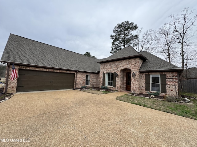 french country style house featuring a garage