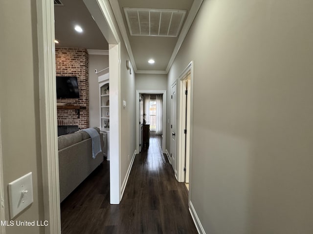 corridor with crown molding, dark hardwood / wood-style floors, and built in features