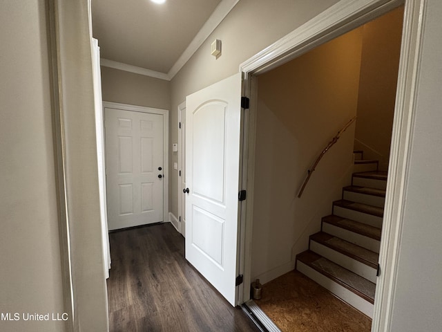 corridor with dark wood-type flooring and ornamental molding