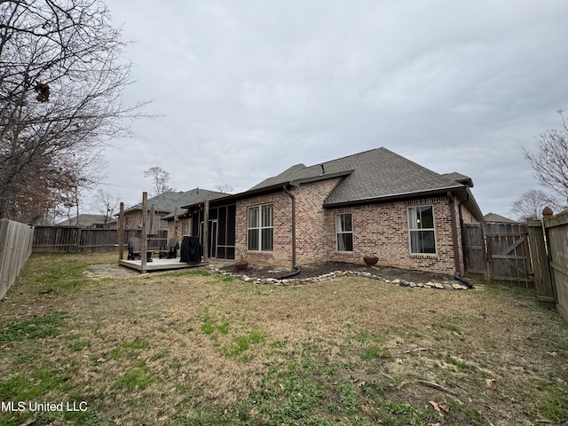 back of house with a yard and a deck