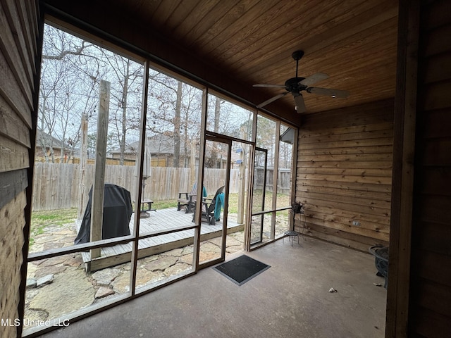 unfurnished sunroom featuring ceiling fan and wood ceiling