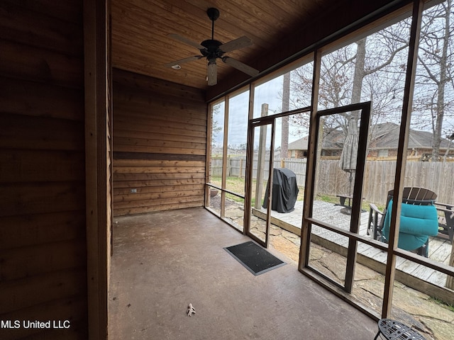 unfurnished sunroom featuring ceiling fan and wood ceiling