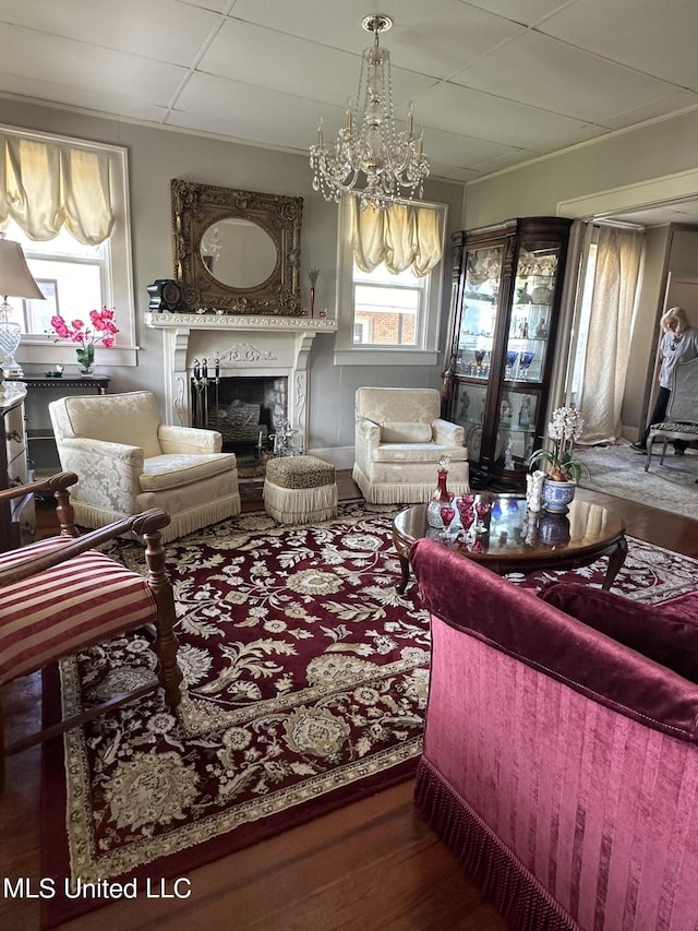 living room with hardwood / wood-style floors, an inviting chandelier, and plenty of natural light