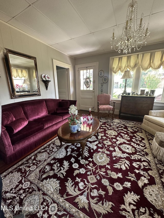 carpeted living room featuring a notable chandelier