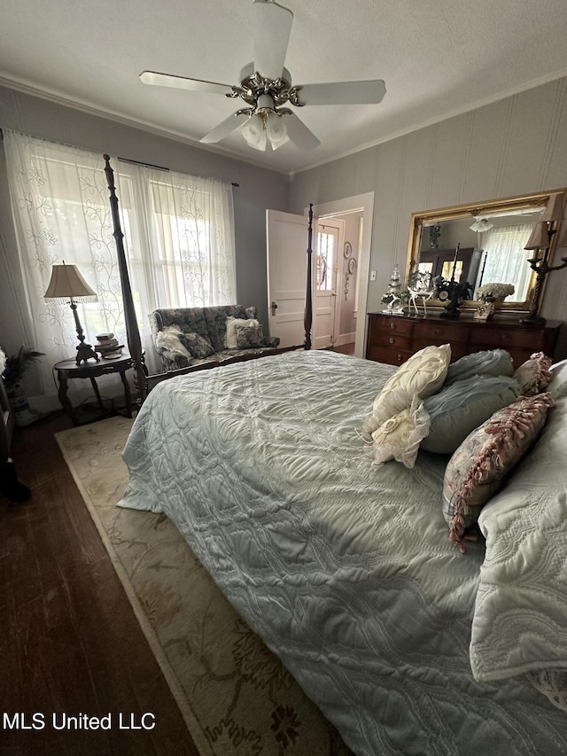 bedroom with ceiling fan, crown molding, and wood-type flooring