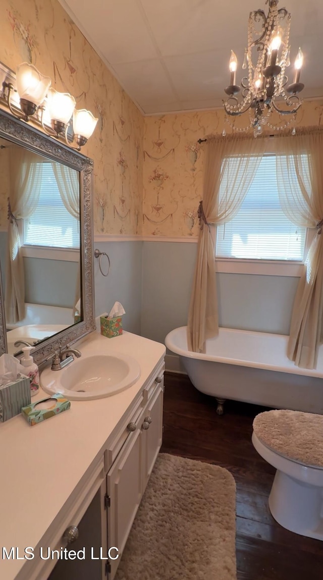 209 S Jackson St, Crystal Springs, MS 39059 - full bathroom with wallpapered walls, wainscoting, a wealth of natural light, and wood finished floors