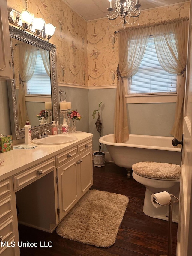 bathroom featuring vanity, hardwood / wood-style floors, and a bath