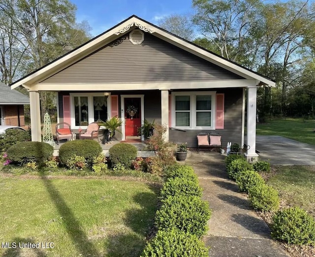 view of front of property with covered porch and a front yard