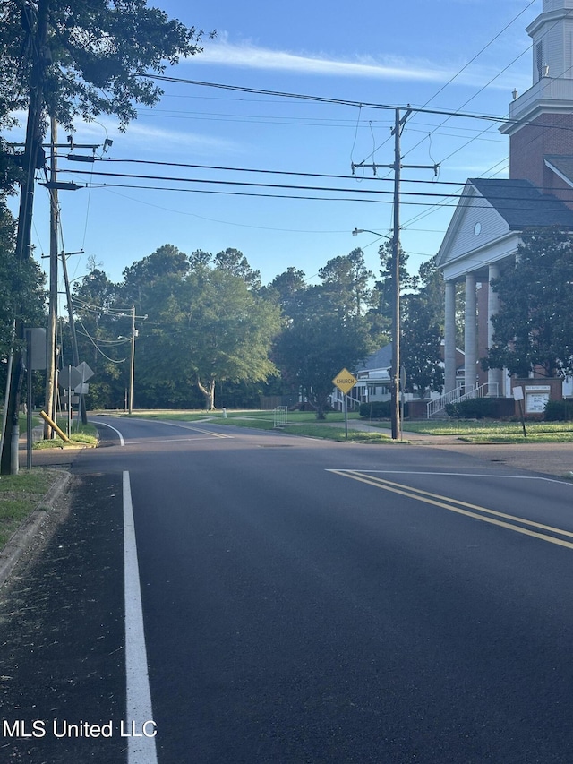 209 S Jackson St, Crystal Springs, MS 39059 - view of road featuring curbs, street lighting, and traffic signs