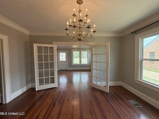 209 S Jackson St, Crystal Springs, MS 39059 - unfurnished dining area with a notable chandelier, a healthy amount of sunlight, visible vents, and baseboards