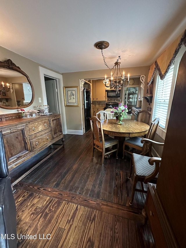 dining area with wood-type flooring and a chandelier