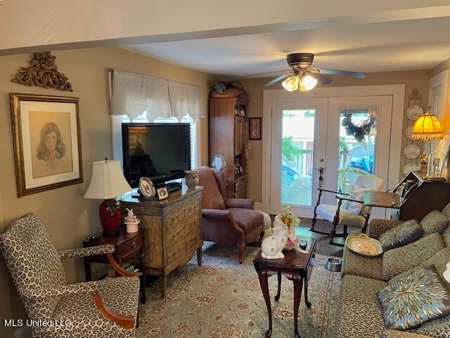 living room featuring french doors and ceiling fan