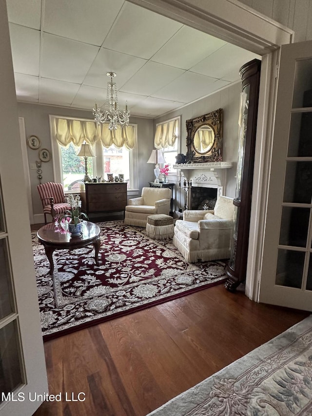 living room featuring a notable chandelier and dark hardwood / wood-style floors